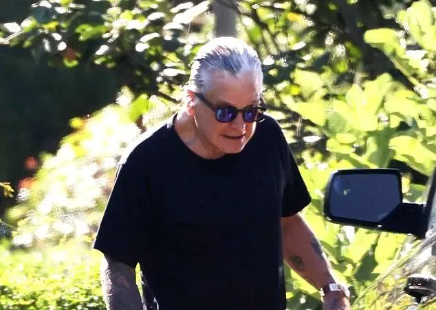 OZZY OSBOURNE Once Again Embracing His Grey Hair While Walking With A Cane